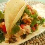 Vegan Tacos with Chipotle Orange-Marinated Tofu (with black beans, kale, tomatoes, Chipotle Orange Sour Cream, cilantro, and toasted pepitas)