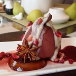 Festive Vegan Wine-Poached Pears with Wine Reduction, Coconut Cream, and Pomegranate Garnish